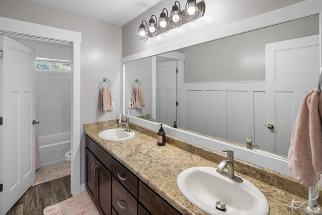 4126 E Cherokee, Eagle Mountain, UT 84005 - bathroom with a sink, double vanity, toilet, and wood finished floors