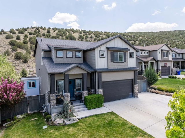 4126 E Cherokee, Eagle Mountain, UT 84005 - view of front of house with board and batten siding, driveway, a garage, fence, and stone siding