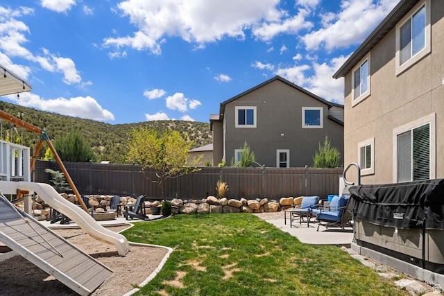 4126 E Cherokee, Eagle Mountain, UT 84005 - view of yard featuring a fenced backyard, a patio area, a mountain view, and an outdoor fire pit