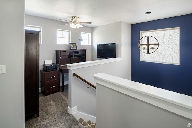 4126 E Cherokee, Eagle Mountain, UT 84005 - hall with baseboards, a notable chandelier, dark carpet, and an upstairs landing