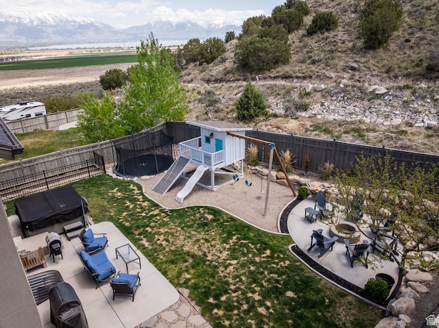 4126 E Cherokee, Eagle Mountain, UT 84005 - view of yard with an outdoor living space, a patio area, a mountain view, a fenced backyard, and a playground