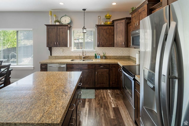 4126 E Cherokee, Eagle Mountain, UT 84005 - kitchen featuring decorative backsplash, appliances with stainless steel finishes, dark wood finished floors, dark brown cabinets, and a sink