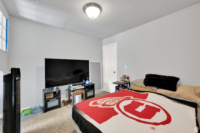 bedroom with baseboards and carpet flooring