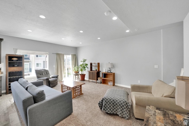 living area featuring recessed lighting and baseboards