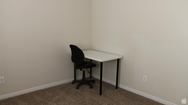 unfurnished office with baseboards and carpet flooring