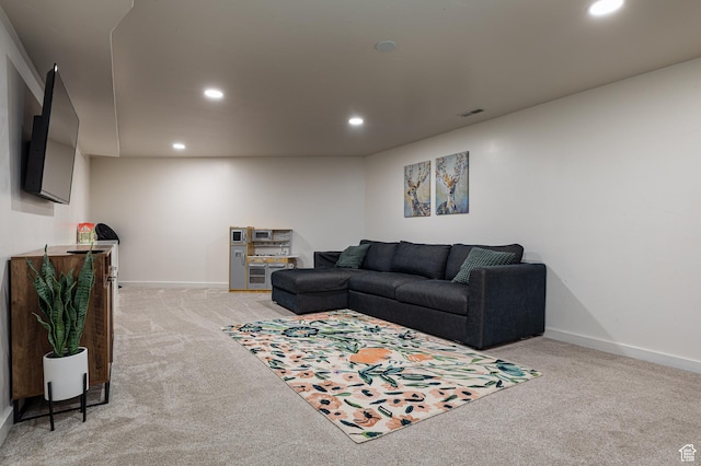 living room with baseboards, visible vents, recessed lighting, and light colored carpet