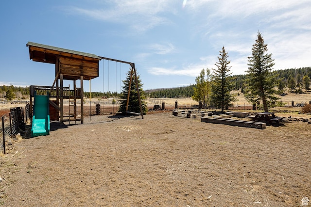 community play area with fence and a rural view