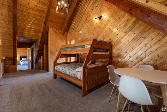 carpeted bedroom with wood walls and vaulted ceiling with beams
