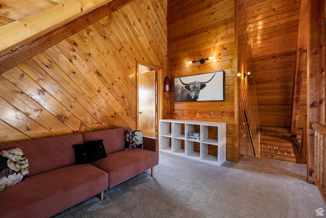 living room with wood walls and carpet flooring