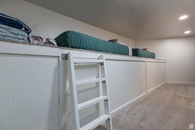 interior details with baseboards, recessed lighting, and carpet