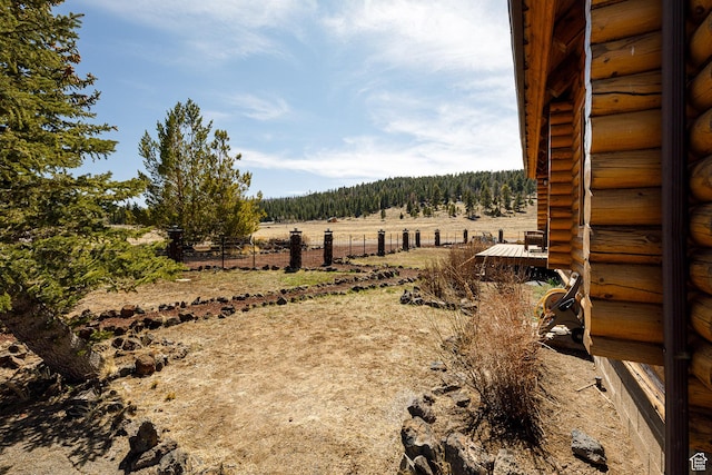 view of yard featuring fence and a rural view