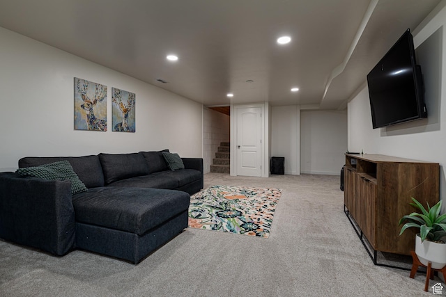 living room with recessed lighting, baseboards, light colored carpet, and visible vents