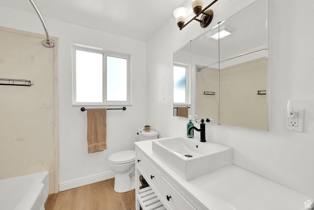 507 N 200 W, Brigham City, UT 84302 - bathroom featuring bathtub / shower combination, vanity, toilet, baseboards, and wood finished floors
