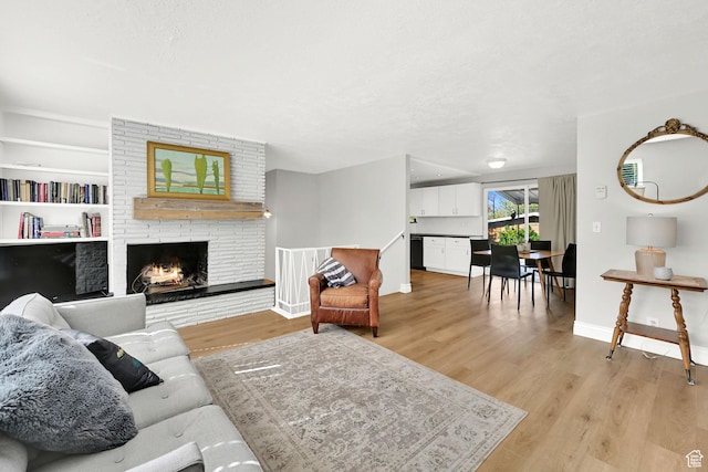 507 N 200 W, Brigham City, UT 84302 - living room featuring light wood-type flooring, a textured ceiling, baseboards, and a fireplace