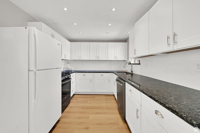 507 N 200 W, Brigham City, UT 84302 - kitchen with freestanding refrigerator, light wood-style floors, white cabinetry, a sink, and black gas range oven