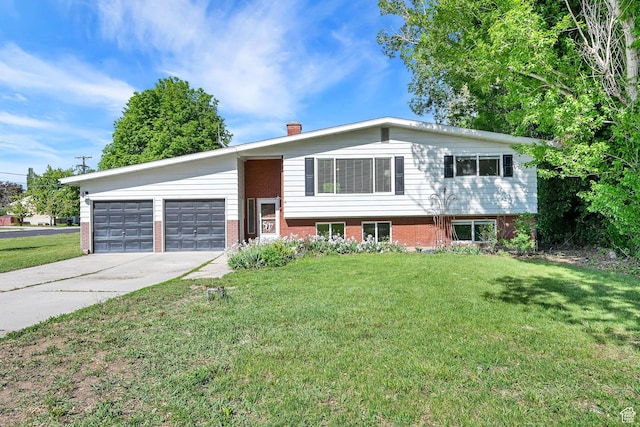 507 N 200 W, Brigham City, UT 84302 - view of front of home with an attached garage, concrete driveway, a front lawn, and brick siding