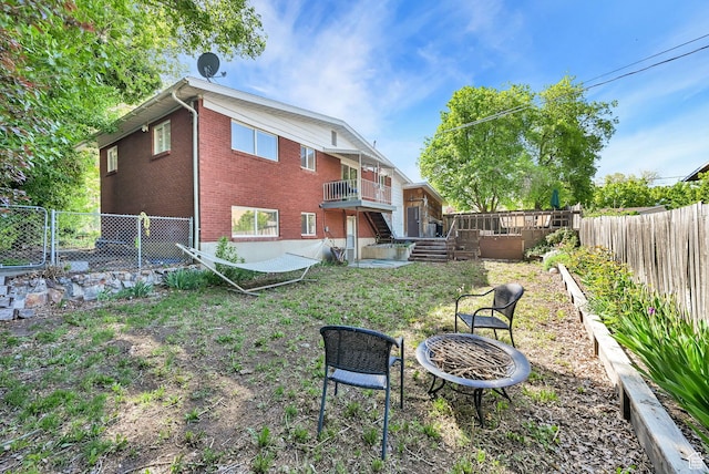 507 N 200 W, Brigham City, UT 84302 - rear view of property with brick siding, a fenced backyard, and a fire pit