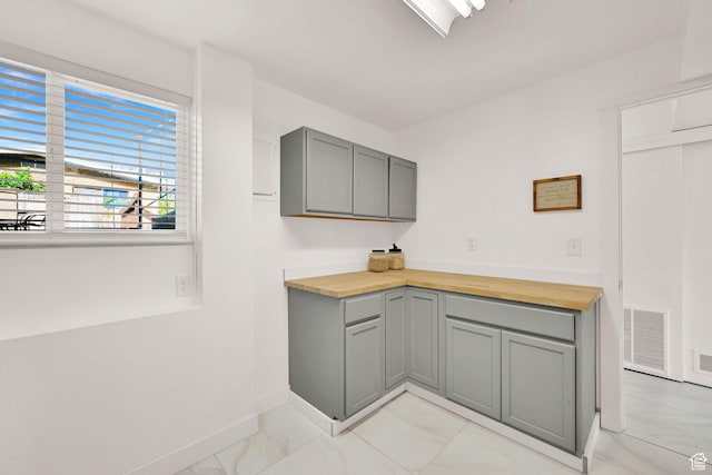507 N 200 W, Brigham City, UT 84302 - kitchen featuring wood counters, gray cabinets, marble finish floor, baseboards, and visible vents