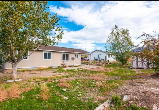 729 Timpie Rd, Tooele, UT 84074 - rear view of house featuring an outbuilding, a storage shed, and entry steps