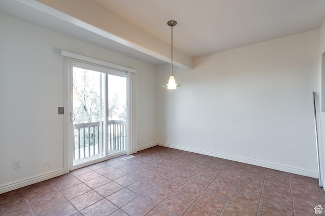 empty room with baseboards and tile patterned flooring