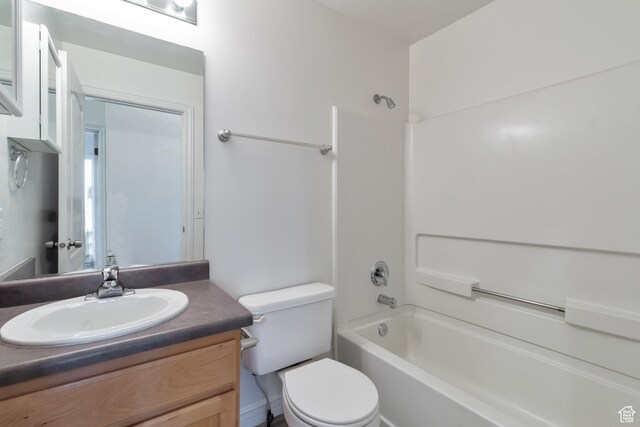 bathroom featuring toilet, shower / tub combination, and vanity
