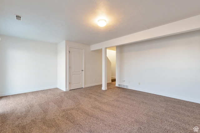 finished below grade area featuring visible vents, carpet flooring, and baseboards