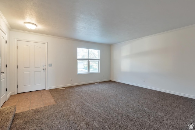 entrance foyer with tile patterned flooring, ornamental molding, carpet, and baseboards