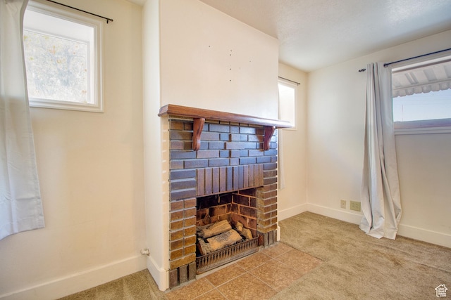 room details featuring baseboards, carpet, and a brick fireplace