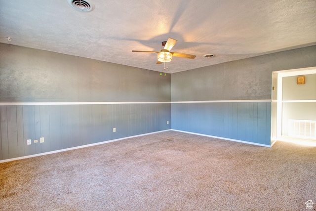 unfurnished room featuring carpet floors, ceiling fan, and visible vents