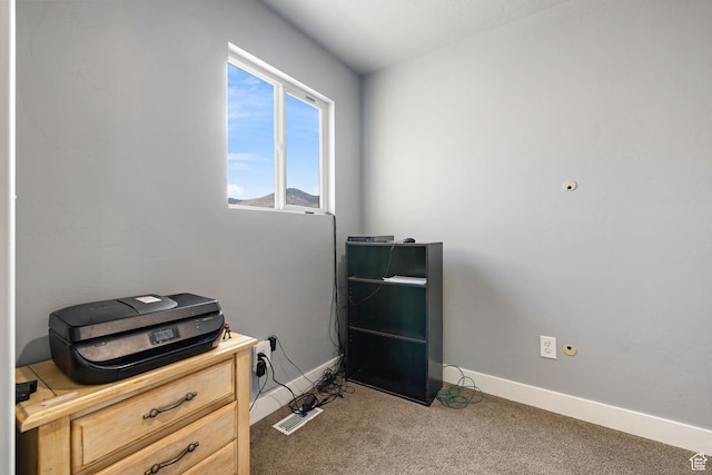 misc room with baseboards and carpet