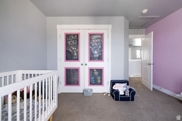 bedroom featuring carpet floors, a closet, a nursery area, and visible vents