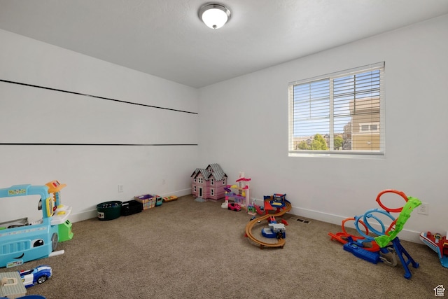 playroom with carpet floors, baseboards, and visible vents