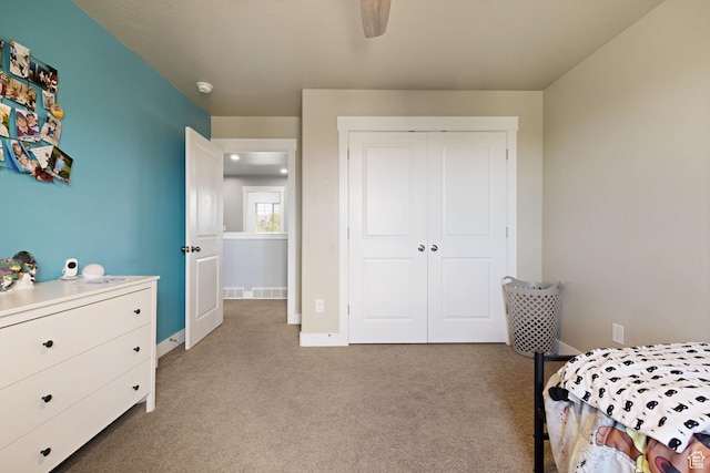 bedroom with a closet, visible vents, light carpet, baseboards, and ceiling fan