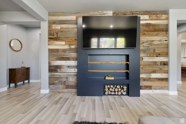 interior space with wooden walls, baseboards, and wood finished floors