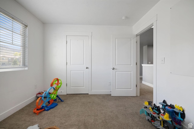 playroom featuring carpet floors and baseboards