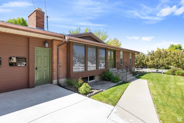 344 E 900 N, Pleasant Grove, UT 84062 - doorway to property with a lawn, brick siding, a chimney, and a patio