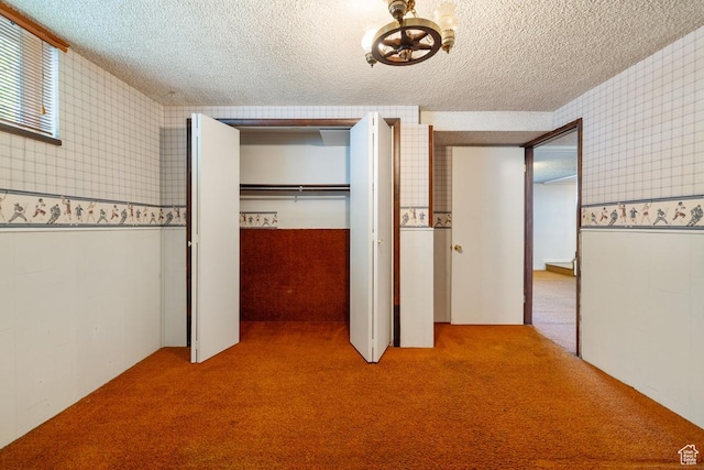 344 E 900 N, Pleasant Grove, UT 84062 - unfurnished bedroom featuring a textured ceiling, wallpapered walls, and carpet