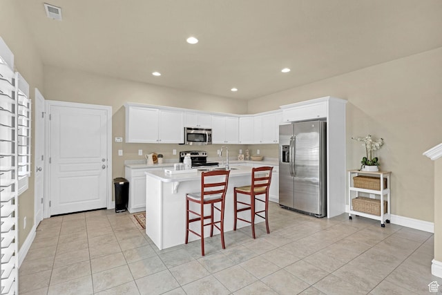 kitchen with visible vents, light countertops, a sink, light tile patterned floors, and stainless steel appliances