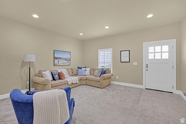carpeted living area with recessed lighting and baseboards