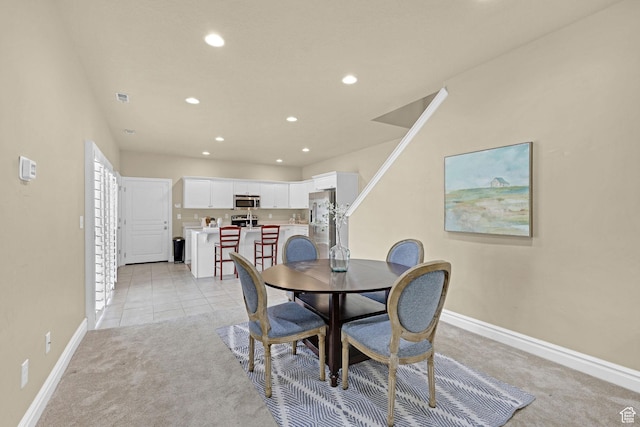 dining space with light colored carpet, recessed lighting, and baseboards