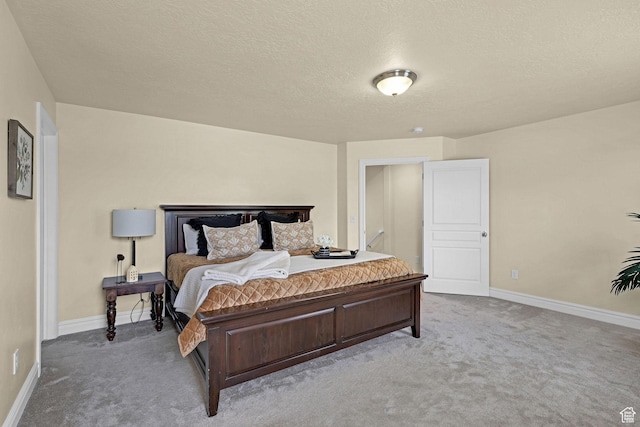 bedroom featuring baseboards, carpet flooring, and a textured ceiling