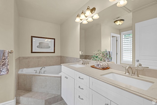 bathroom with visible vents, a sink, and a garden tub