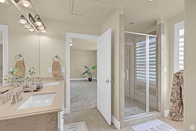 full bathroom featuring double vanity, tile patterned floors, a sink, and a stall shower