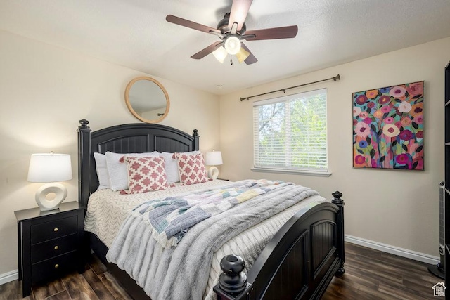 bedroom with dark wood-style flooring, baseboards, and ceiling fan