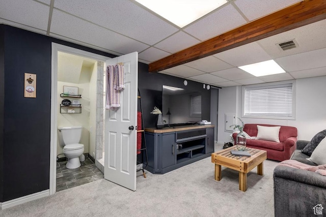 living area featuring light colored carpet, visible vents, and a drop ceiling