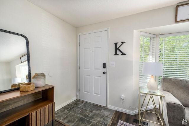foyer entrance featuring baseboards and visible vents