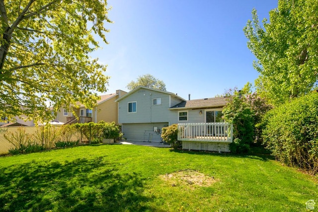 rear view of property with a lawn and a wooden deck