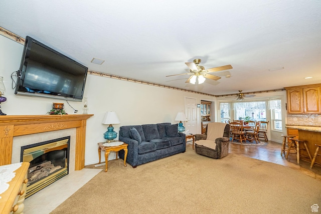 2983 W 2600 N, Plain City, UT 84404 - living area with light tile patterned floors, a fireplace, and a ceiling fan