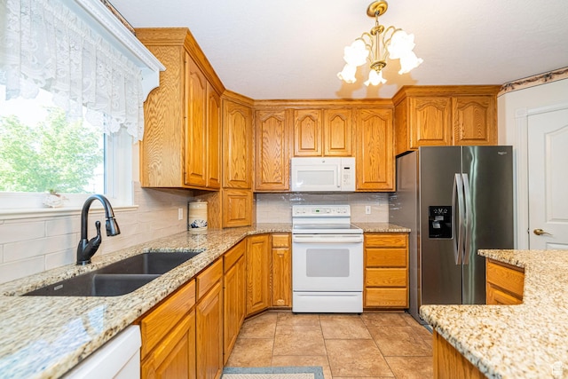 2983 W 2600 N, Plain City, UT 84404 - kitchen with white appliances, a chandelier, light stone counters, a sink, and backsplash