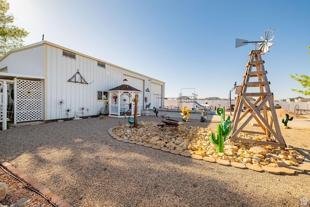 2983 W 2600 N, Plain City, UT 84404 - view of front facade with board and batten siding and a playground